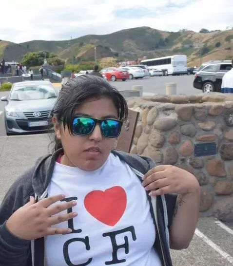 AI Video from prompt: She takes off her hoodie sweater