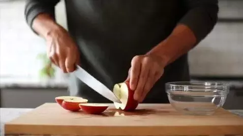 AI Video from prompt: Man cutting apple