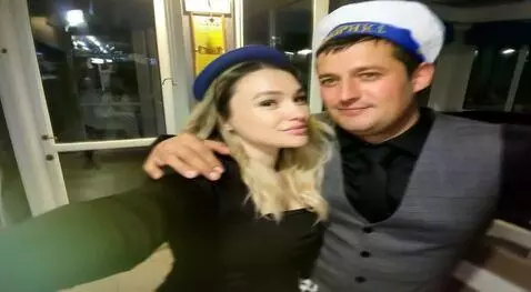 AI Video from prompt: A couple takes a selfie in front of a glass door