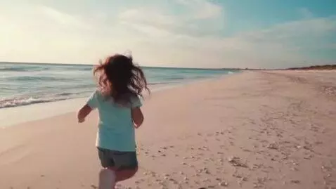 AI Video from prompt: young girl running down the beach