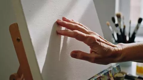 AI Video from prompt: The hand touches the real, rough, paint-smelling