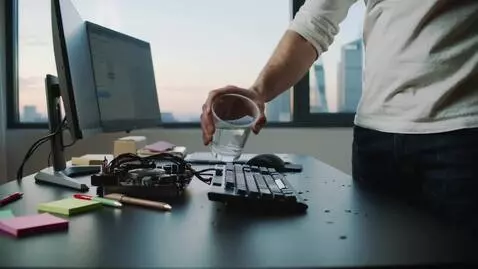 AI Video from prompt: a man fills his computer with water