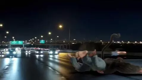 AI Video from prompt: giant monkey man runs across a freeway and a car