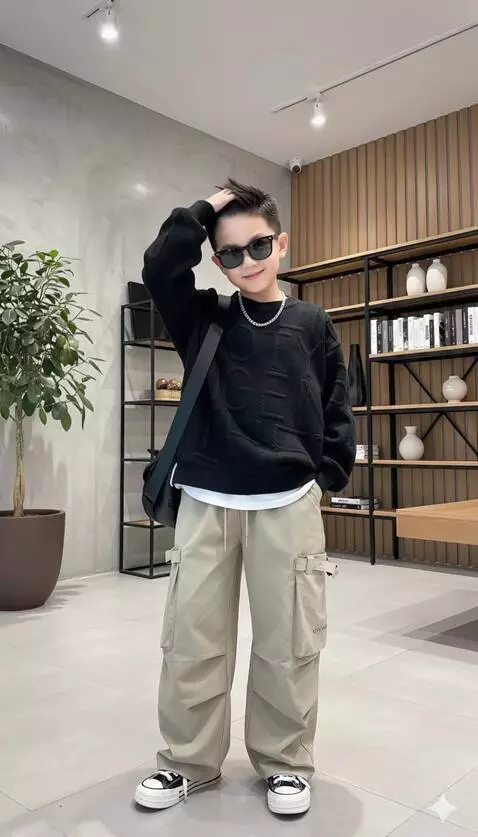 AI Video from prompt: The boy fixes his hair with a slight smile, then