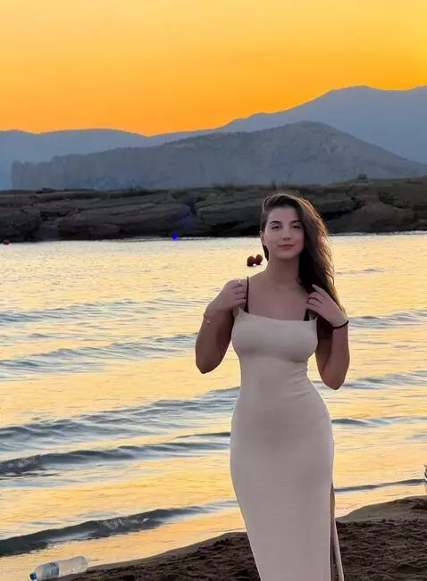 AI Video from prompt: She takes off her robe, under the robe is a shor