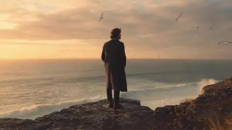 AI Video from prompt: A slow cinematic shot of a man standing on a win