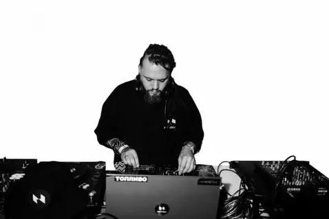 AI Video from prompt: The DJ mixes the music, sometimes smoothly pulli