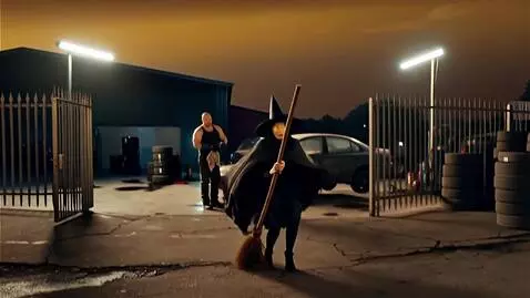 AI Video from prompt: A witch descends from the sky on a broomstick, f