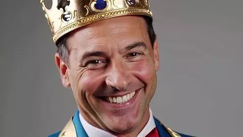 AI Video from prompt: President trump wearing a crown smiling and wink