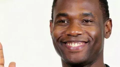 AI Video from prompt: The guy smiles and waves his hand