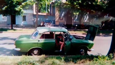 AI Video from prompt: He gets into the driver's seat of this car and d