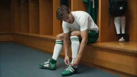 AI Video from prompt: A soccer player in the locker room. He looks at 