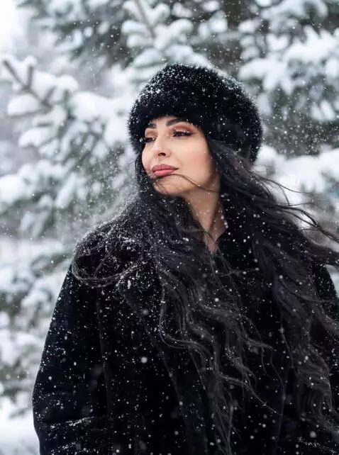 AI Video from prompt: The girl is enjoying the snowfall, her hair blow