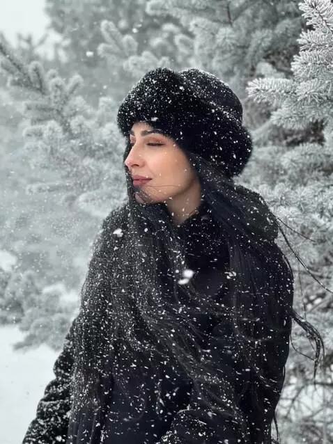 AI Video from prompt: The girl is enjoying the snowfall, her hair blow