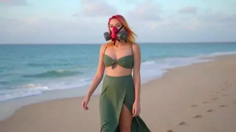 AI Video from prompt: the girl is wearing a red respirator, she has bl