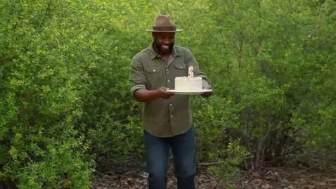 AI Video from prompt: A dark-skinned man in a hat is dancing in the bu