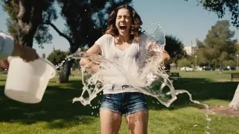 AI Video from prompt: "A young woman in her mid-20s with long wavy bro