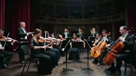 AI Video from prompt: Orchestra playing in first, dramatic sceane