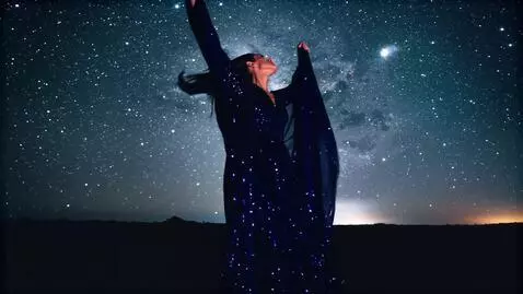 AI Video from prompt: A mesmerizing midnight scene where a lone woman 