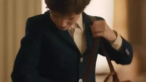 AI Video from prompt: A boy in a jacket that's buttoned up from the bo