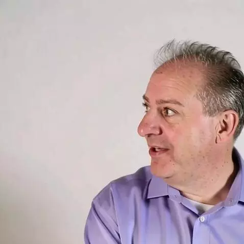 AI Video from prompt: Make the person smile in the picture and look ar