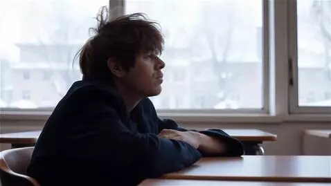 AI Video from prompt: The camera refocuses on the view outside the win