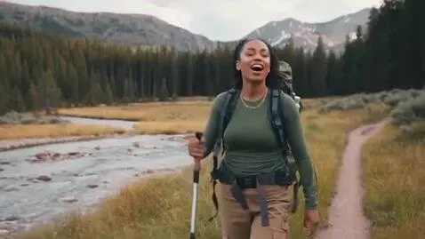 AI Video from prompt: A women  hiking through Yellow Stone national pa