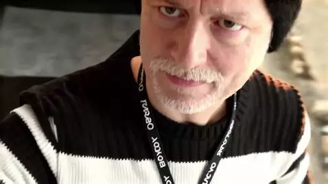 AI Video from prompt: {   "scene": "Aerial drone view of man with red 