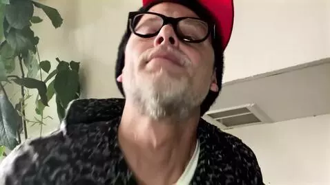 AI Video from prompt: {   "scene": "Aerial drone view of man with red 