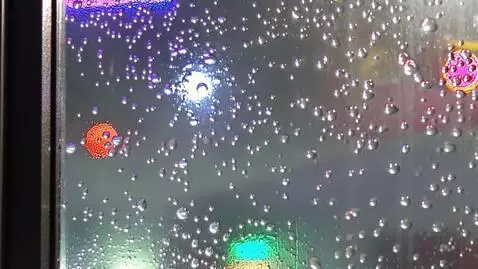 AI Video from prompt: Rain sliding down a glass window at night, neon 