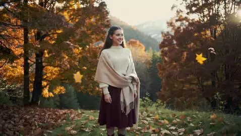AI Video from prompt: A beautiful girl stands and smiles, autumn leave