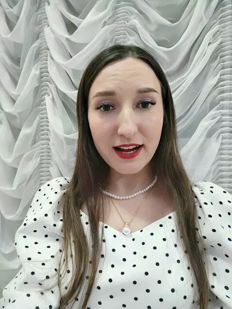 AI Video from prompt: a woman with black stockings wit in bed and talk