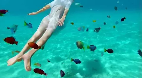 AI Video from prompt: a woman floating on her back in the turquoise bl