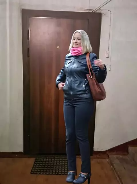 AI Video from prompt: The woman turns to the door, walks up to the doo
