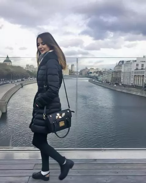 AI Video from prompt: A young woman wearing a small black Crocs on her