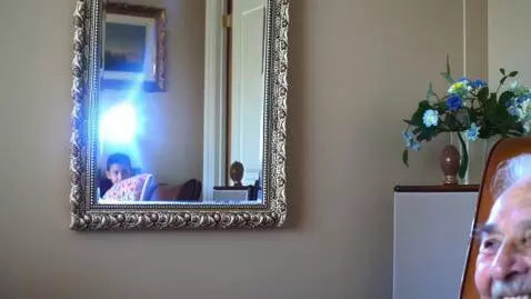 AI Video from prompt: A boy catches the reflection from a mirror on th