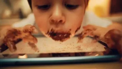 AI Video from prompt: kid playing on a greasy ipad