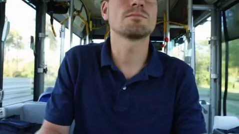 AI Video from prompt: Bus driver driving a bus with a dark blue polo s