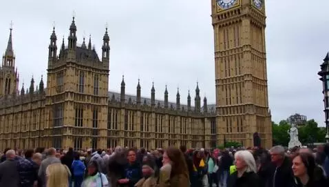 AI Video from prompt: Worlds biggest clock and many people watching it