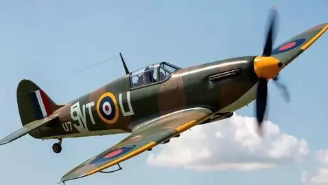 AI Video from prompt: A shiny newly painted spitfire makes a fly by