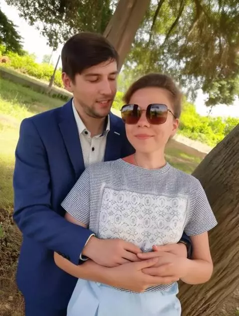 AI Video from prompt: The man whispers something in the girl's ear, sh