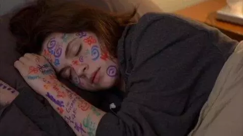 AI Video from prompt: woman sleeping body painted with permanent marke