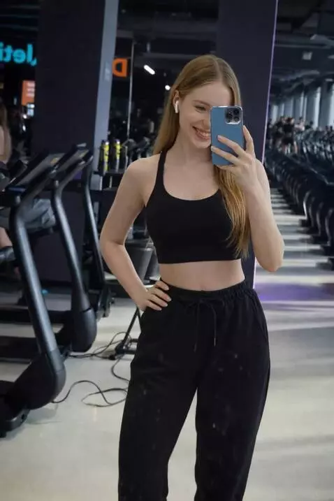 AI Video from prompt: shows off in front of the mirror, takes two step