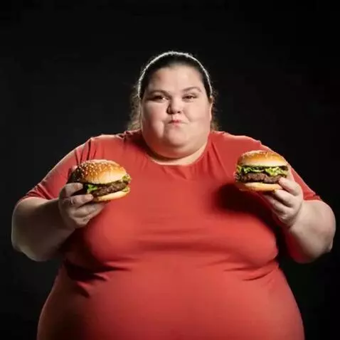 AI Video from prompt: the obese woman's face and chest begins to expan