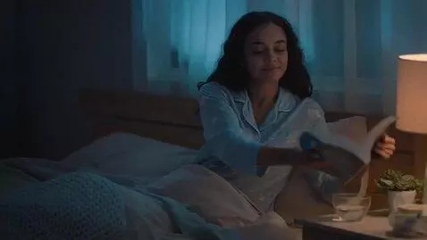 AI Video from prompt: A cozy dimly lit bedroom at night, soft warm bed