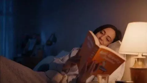 AI Video from prompt: A cozy dimly lit bedroom at night, soft warm bed