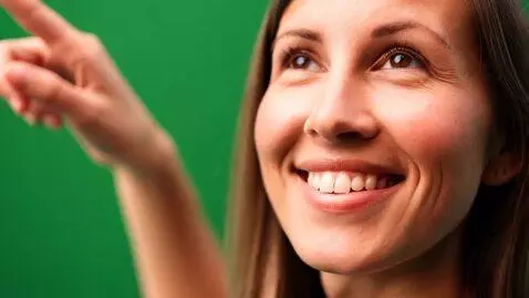 AI Video from prompt: A person with a green screen background, smiling