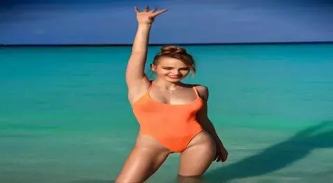 AI Video from prompt: The girl poses for the camera, smiles and waves 