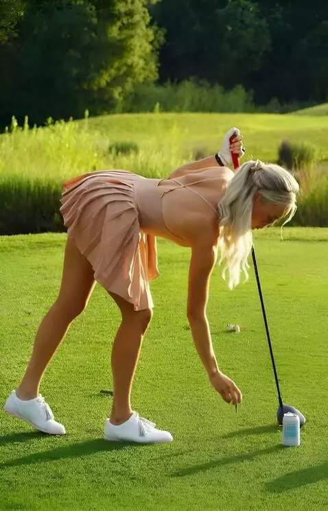 AI Video from prompt: A golfer in a skirt bends over and places the ba