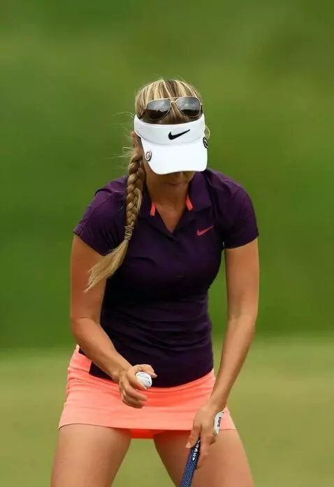 AI Video from prompt: A golfer in a skirt bends over and places the ba